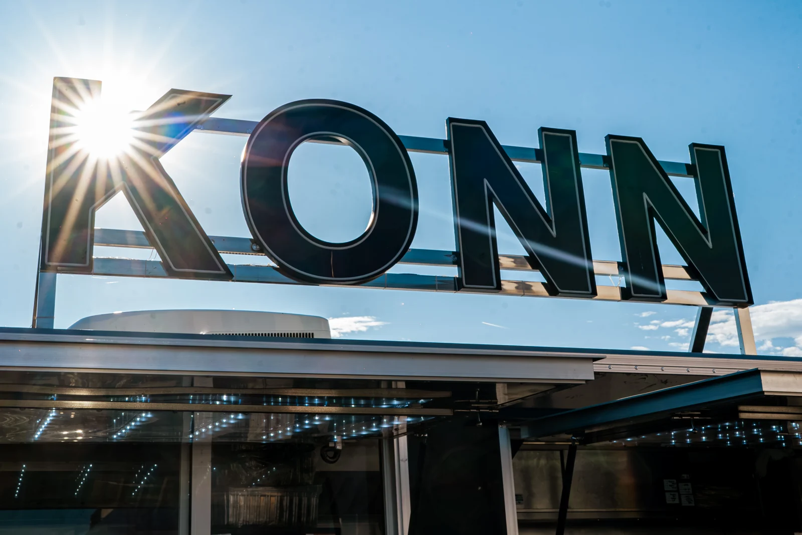 Close-up of the KONN logo in sunlight